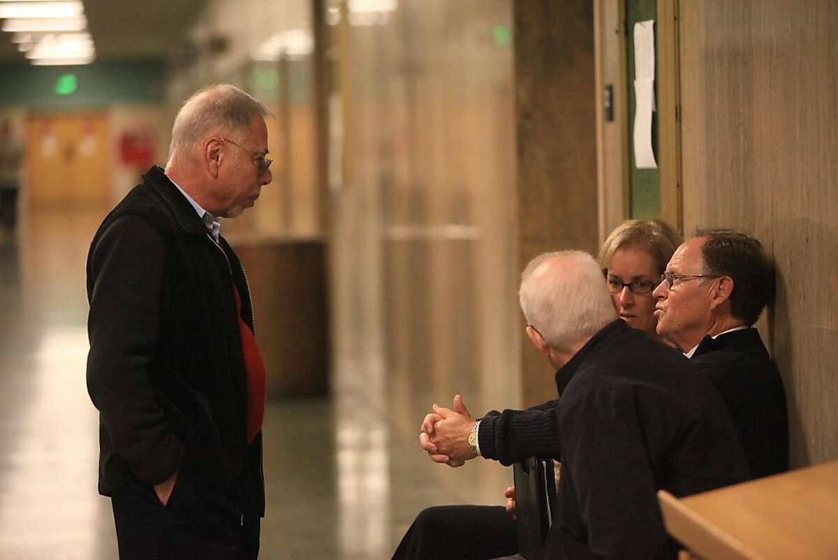 Former associate vice chancellor of City College of San Francisco Stephen Herman (left) and former City College of San Francisco Chancellor Philip Day (right) talk outside of Department 22 before being sentenced at the Hall of Justice on Tuesday, November 1, 2011 in San Francisco, Calif.