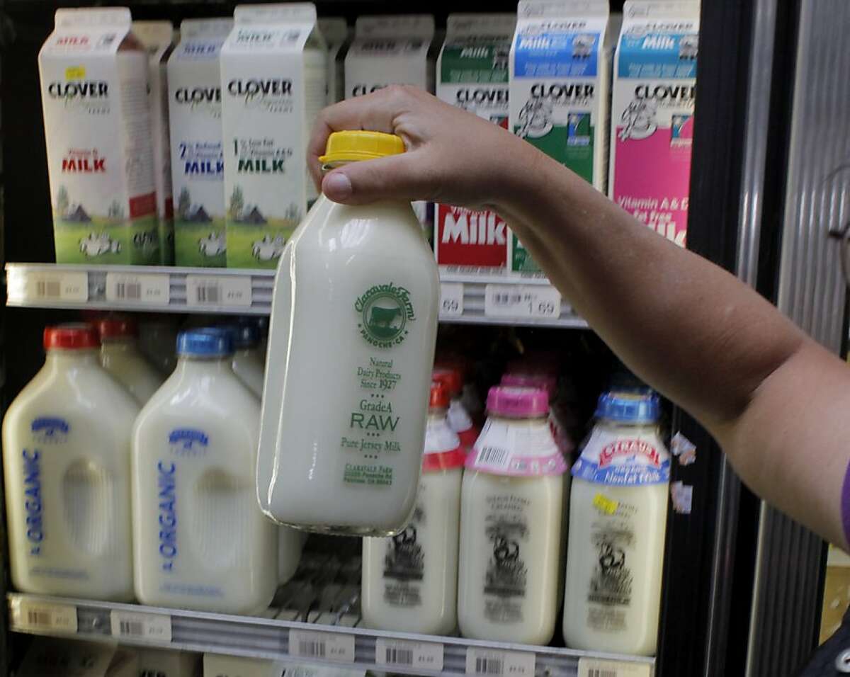 The last bottle of raw milk is taken off the shelf, Thursday May 19, 2011, at the Other Avenues Market in San Francisco, Calif. The federal government is sending SWAT teams out to raw milk producers in an effort to get them to stop spreading un-pasturized milk to the masses. Ran on: 05-22-2011 Other Avenues Market in San Francisco carries raw milk, which drinkers say has better flavor and more nutrients.