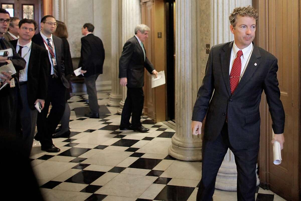 WASHINGTON, DC - NOVEMBER 29: U.S. Sen. Rand Paul (R-KY) (R) leaves the weekly Senate Republican policy luncheon at the U.S. Captiol November 29, 2011 in Washington, DC. The Senate Democratic and Republican caucuses met separately behind closed doors to discuss the annual $226 billion Defense Authorization legislation. The White House has threatened to veto the military spending bill over parts of the bill requiring that al-Qaeda members captured on US soil be held by the military and not civilian authorties. Senate Armed Services Committee ranking member U.S. Sen. John McCain (R-AZ) said there was a robust debate on the detainee issue during the GOP luncheon, but Cheney did not join the discussion. (Photo by Chip Somodevilla/Getty Images)