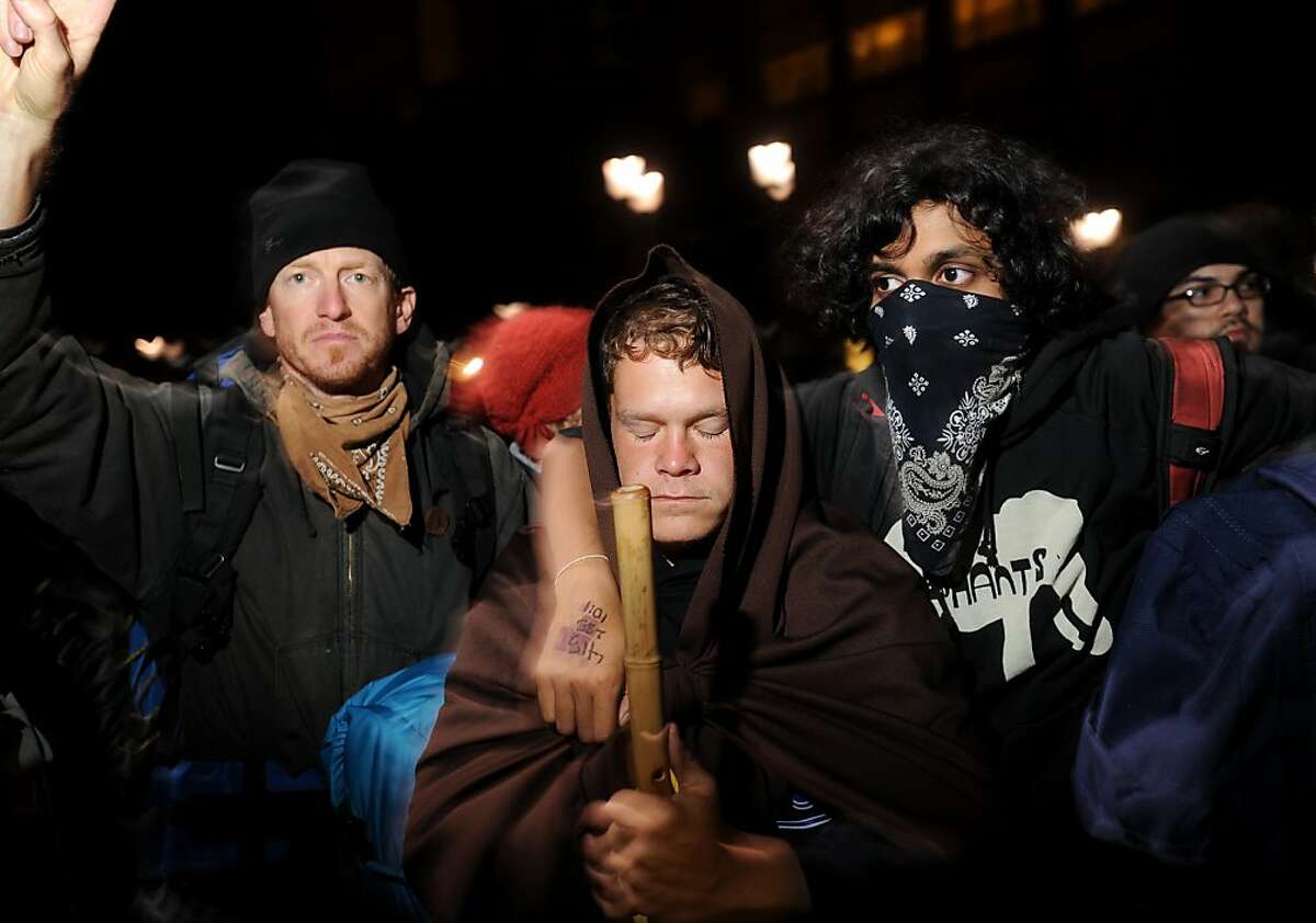 Occupy Oakland protesters link arms as police advance on their city hall encampment on Tuesday, Oct. 25, 2011, in Oakland, Calif. During a widespread overnight operation, police cleared Occupy Oakland's two camps and arrested protesters.