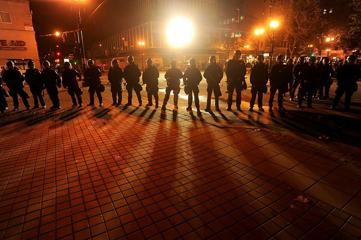 Clad in riot gear, police advance on Occupy Oakland's city hall encampment on Tuesday, Oct. 25, 2011, in Oakland, Calif.