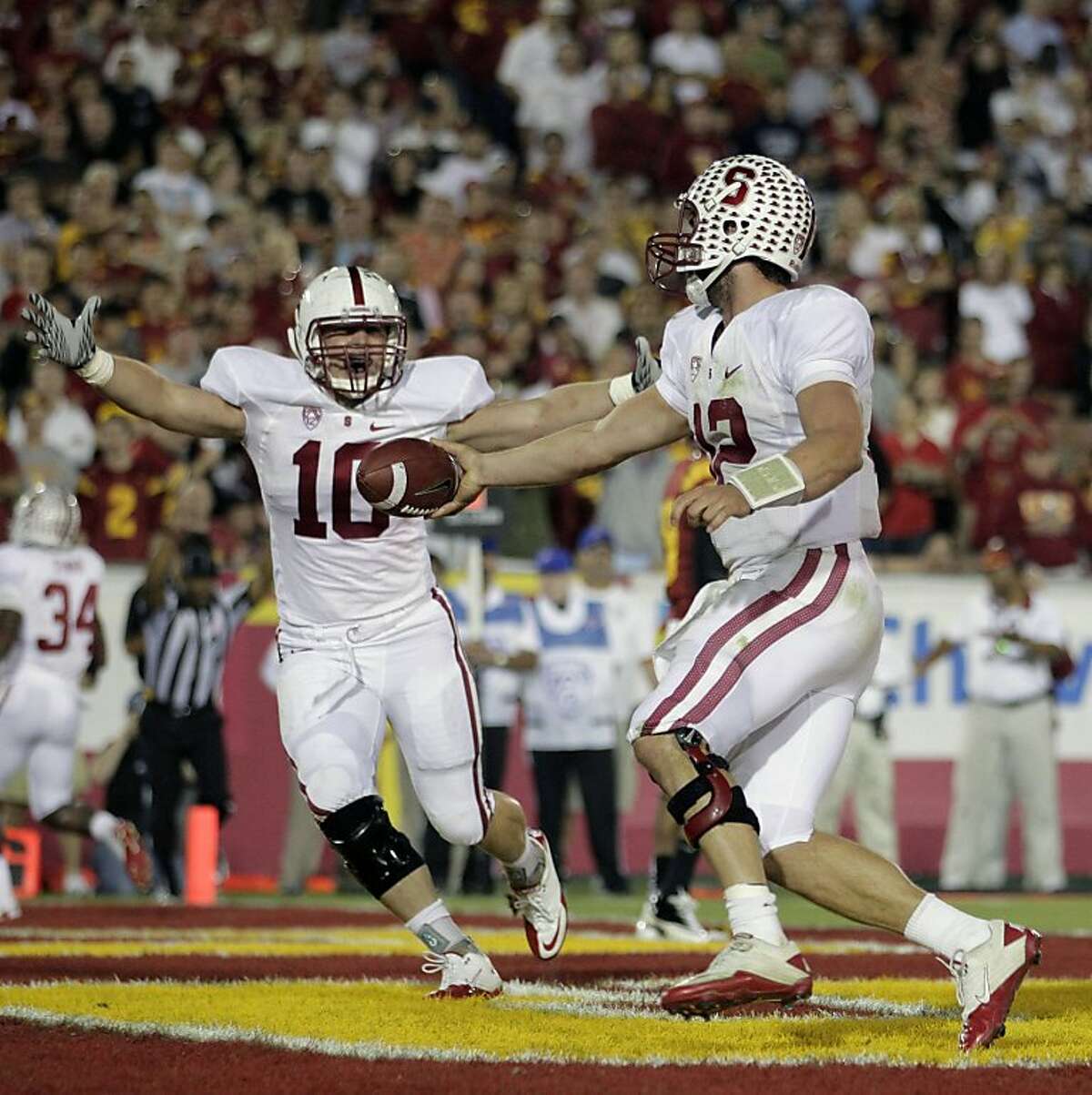 Stanford quarterback Andrew Luck, center, and fullback Geoff Meinken (10) celebrate after Luck scored a touchdown during the second half of an NCAA college football game in Los Angeles, Saturday, Oct. 29, 2011. Stanford won 56-48 in overtime. (AP Photo/Jae C. Hong) Ran on: 10-30-2011 Andrew Luck had his tough moments, but he ran for a touchdown in the second half and threw for three in the triple-overtime win against USC. Ran on: 10-30-2011 Andrew Luck had his tough moments, but he ran for a touchdown in the second half and threw for three in the triple-overtime win against USC. Ran on: 10-30-2011 Andrew Luck had his tough moments, but he ran for a touchdown in the second half and threw for three in the triple-overtime win against USC. Ran on: 10-30-2011 Andrew Luck had his tough moments, but he ran for a touchdown in the second half and threw for three in the triple-overtime win against USC.