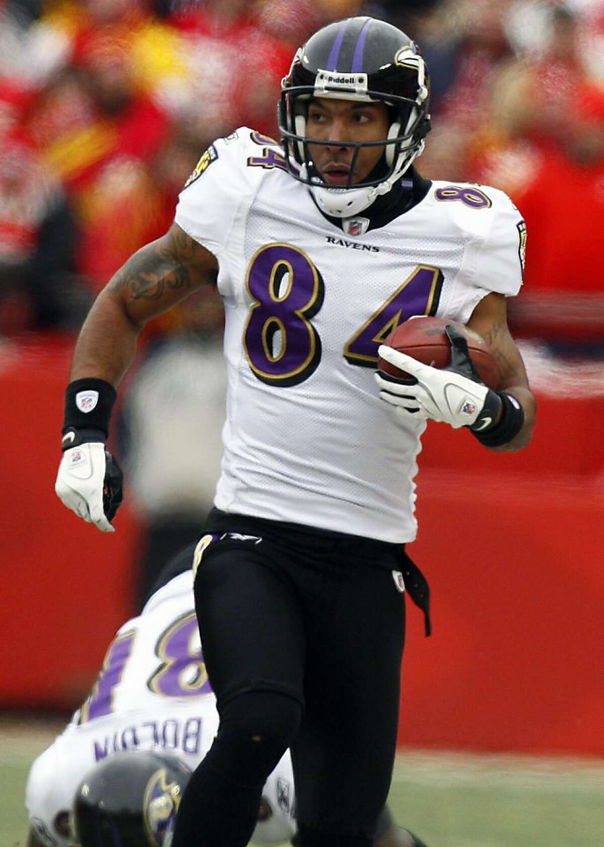 FILE - In this Jan. 9, 2011 file photo, Baltimore Ravens' T.J. Houshmandzadeh (84) runs for yardage against the Kansas City Chiefs during an NFL AFC wild card football playoff game in Kansas City, Mo. The Oakland Raiders have signed Houshmandzadeh to a contract, the team announced Tuesday, Nov. 1, 2011, after watching the wide receiver work out. The deal reunites Houshmandzadeh with Raiders quarterback Chris Palmer, who was his teammate in Cincinnati for six seasons. (AP Photo/Ed Zurga, File) Ran on: 11-02-2011 T.J. Houshmandzadeh signed with the Raiders on Tuesday. Ran on: 11-02-2011 T.J. Houshmandzadeh signed with the Raiders on Tuesday.