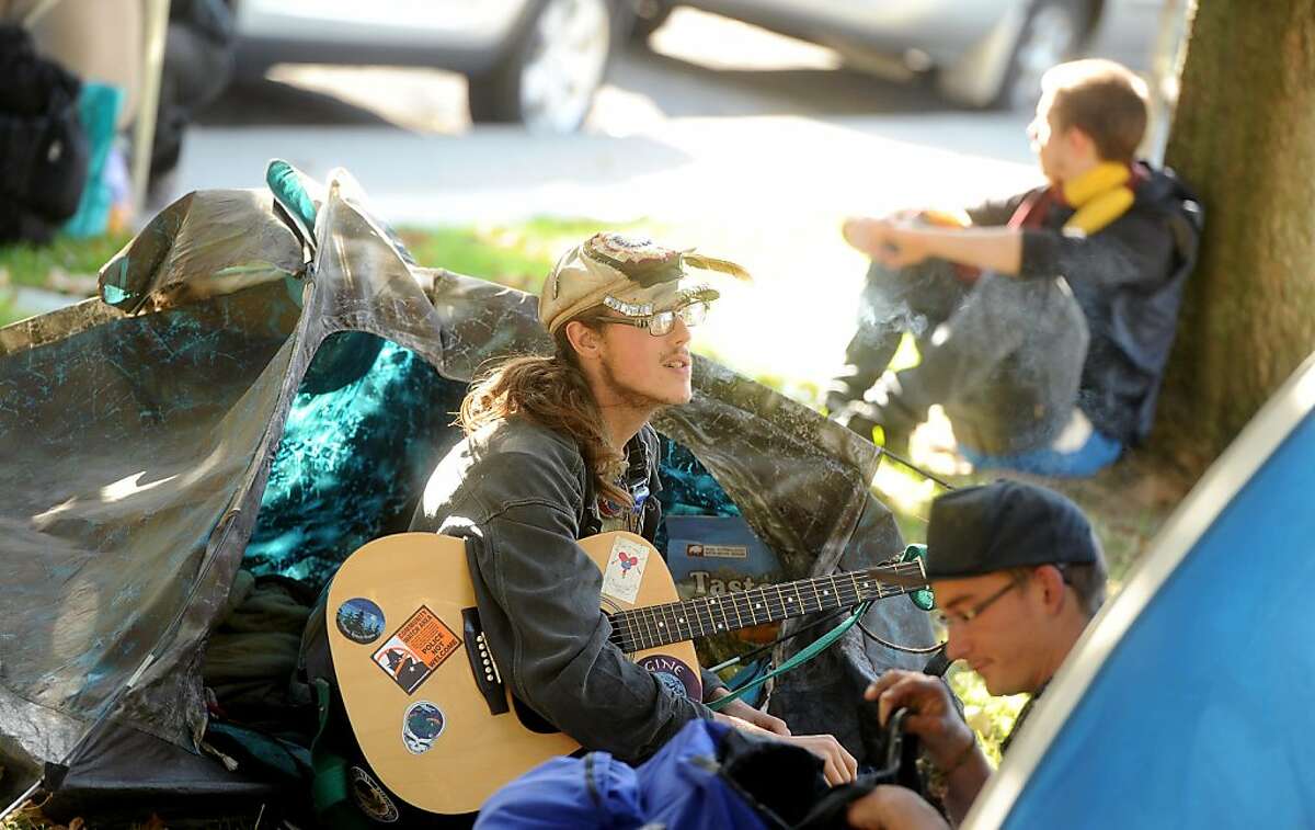 Occupy Berkeley protester Johnny Fish plays guitar outside his tent on Tuesday, Nov. 1, 2011, in Berkeley, Calif. As of Tuesday, about 30 tents dotted Civic Center Park.