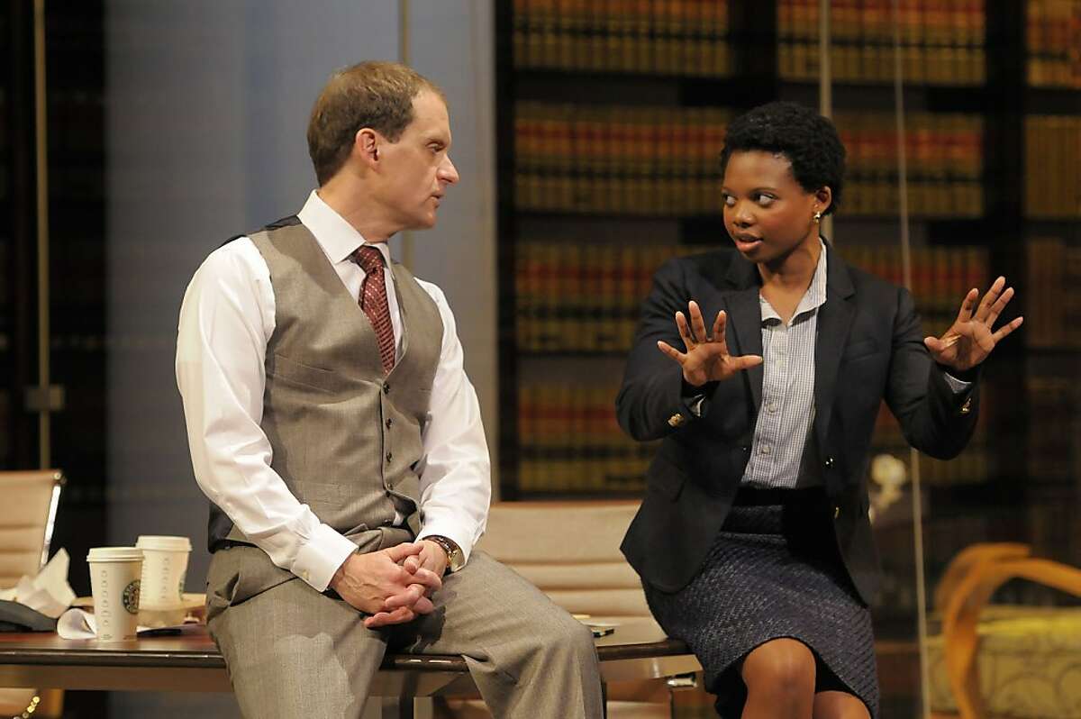 Law firm partner Jack Lawson(Anthony Fusco) and associate Susan (Susan Heyward) discuss the defense of a wealthy white man accused of raping a black woman in David Mamet's "Race" at ACT