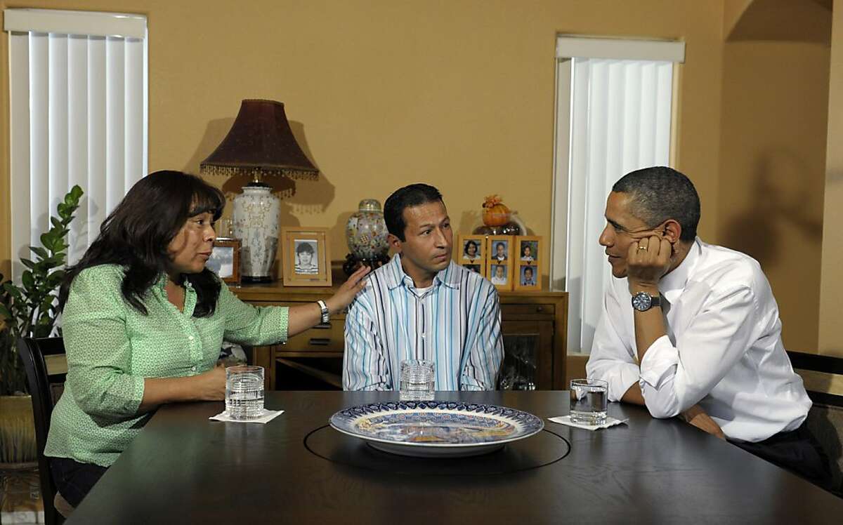 President Barack Obama talks with homeowners Jose and Lissette Bonilla in Las Vegas, Monday, Oct. 24, 2011. Obama is on a three-day trip to the West Coast. (AP Photo/Susan Walsh)