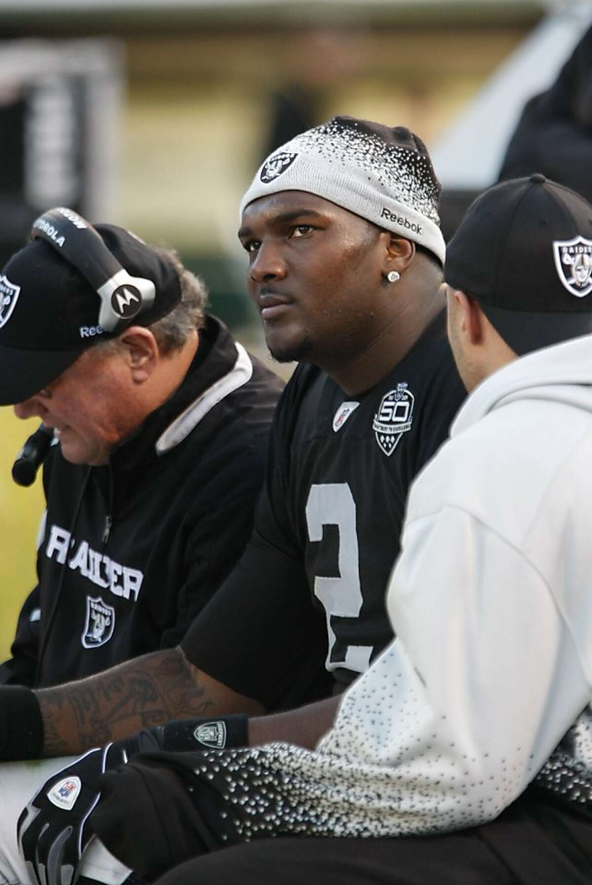 FILE - This Jan. 3, 2010, file photo shows Oakland Raiders quarterback JaMarcus Russell (2) on the sidelines in the fourth quarter of an NFL football game against the Baltimore Ravens, in Oakland, Calif. As Russell struggled through the worst statistical season for an NFL quarterback in more than a decade, Oakland Raiders owner Al Davis preached patience. (AP Photo/Paul Sakuma, File) Ran on: 04-29-2010 JaMarcus Russell: Will he or wont he be at minicamp this week?