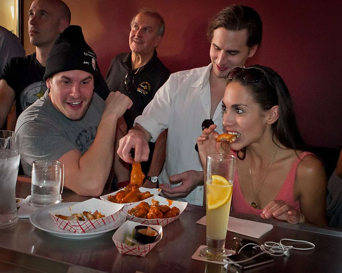 People enjoy Chicken Wings at Giordano Brothers Restaurant in San Francisco, Calif., on Sunday, October 23, 2011.