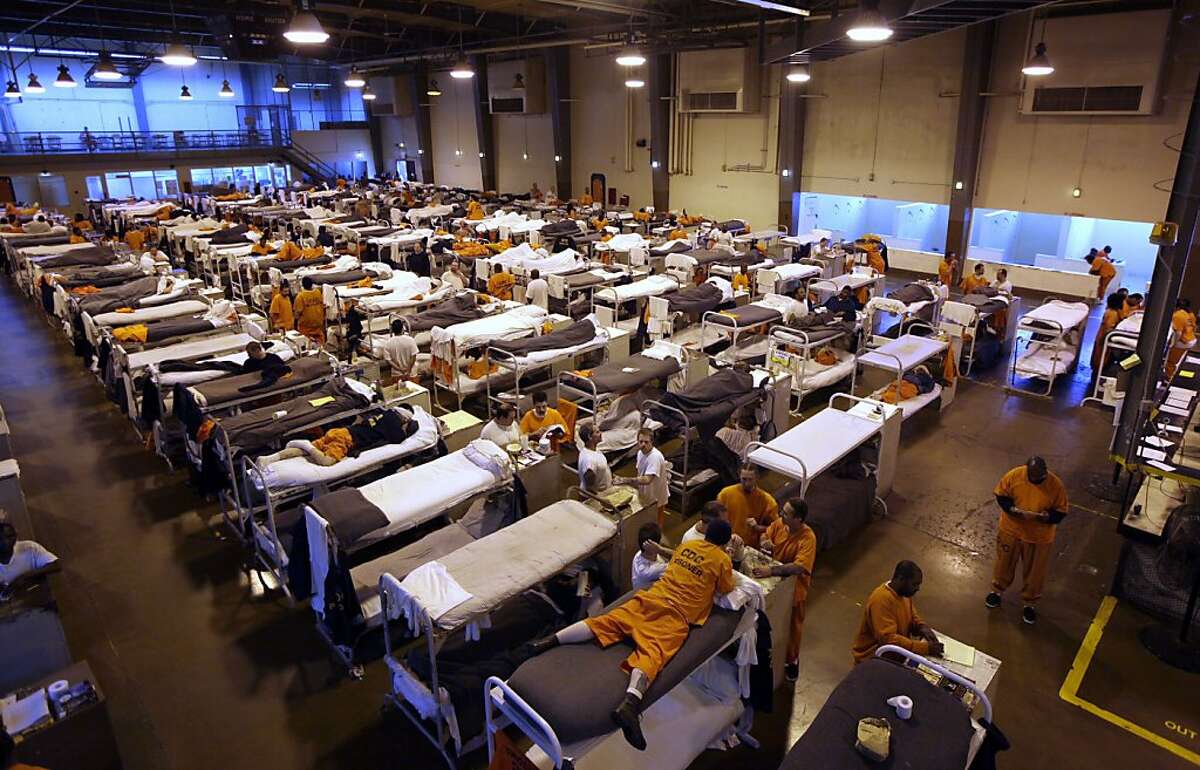 FILE - In this May 20, 2009 file photo, several hundred inmates crowd the gymnasium at San Quentin prison in San Quentin, Calif. The Supreme Court on Monday, May 23, 2011, endorsed a court order requiring California to cut its prison population by tens of thousands of inmates to improve health care for those who remain behind bars. The court said in a 5-4 decision that the reduction is "required by the Constitution" to correct longstanding violations of inmates' rights. The order mandates a prison population of no more than 110,000 inmates, still far above the system's designed capacity. (AP Photo/Eric Risberg, File)