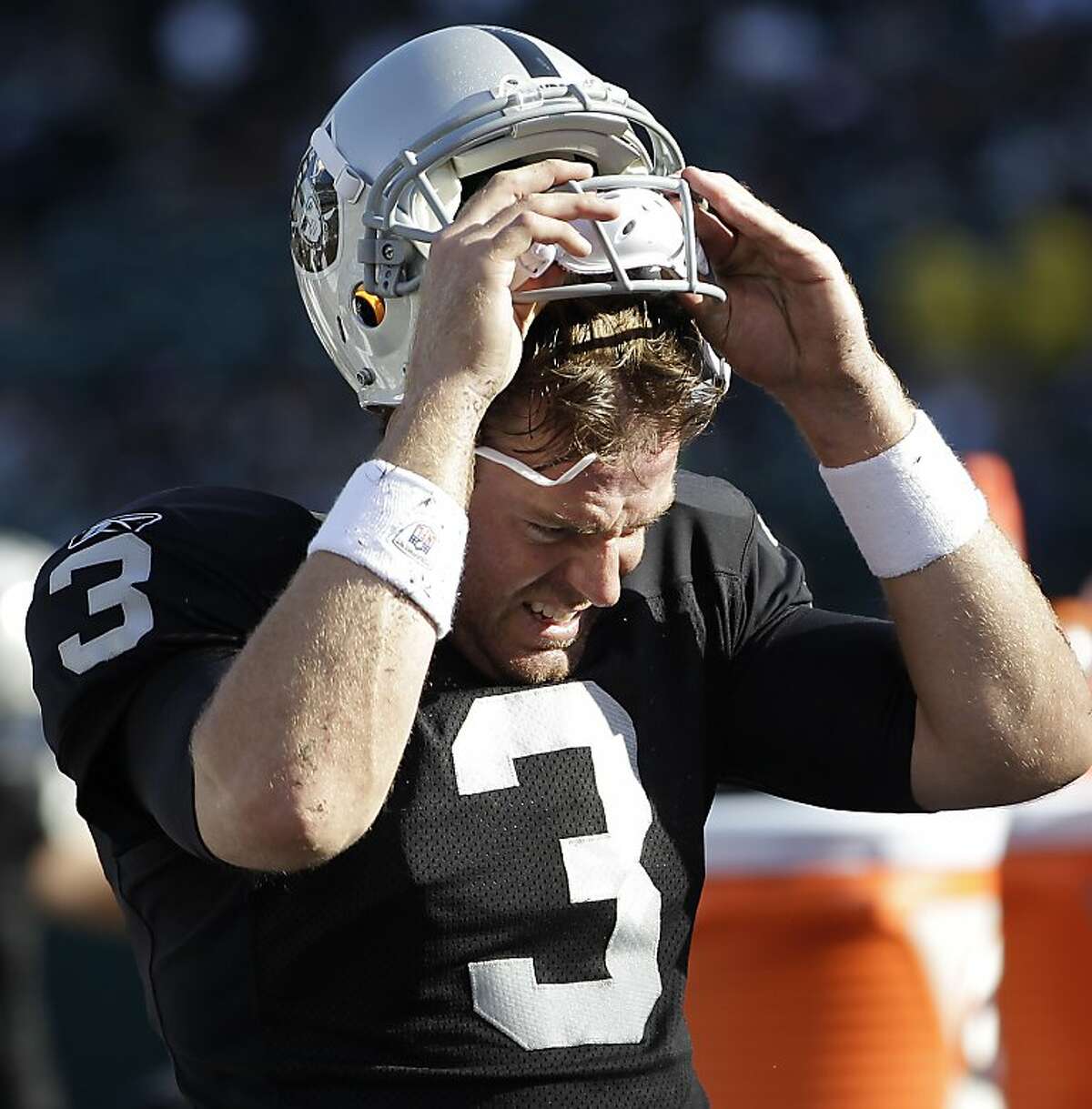 Oakland Raiders quarterback Carson Palmer walks to the sideline in the fourth quarter of an NFL football game against the Kansas City Chiefs in Oakland, Calif., Sunday, Oct. 23, 2011. (AP Photo/Paul Sakuma)