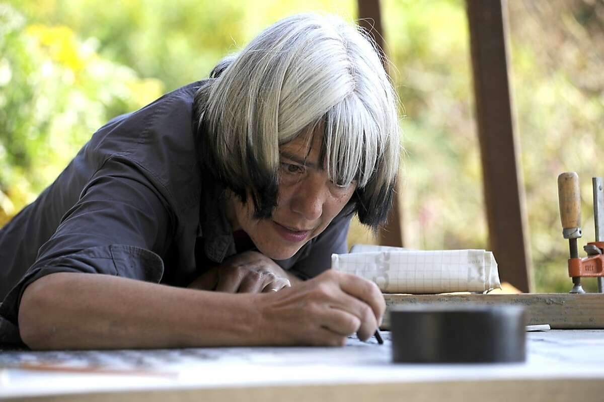 Landscape Architect/Artist Shirley Watts works on an engraving of a Sylvia Plath poem which is part of her installation "Garden of Mouthings" at UC Berkeley Botanical Gardens September 14th, 2011. By Michael Short/Special to the Chronicle