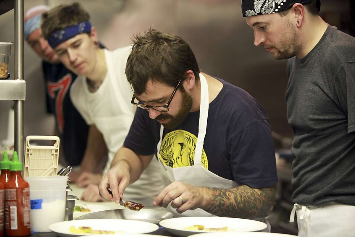 Vinny Dotolo, center, one of the chefs at Animal Restaurant, in Los Angeles, Oct. 14, 2011. In protest of the state's pending ban of foie gras, the fattened liver of a goose or a duck, the restaurant on Friday night served an eight-course foie gras dinner, which cost $175 a person. (Monica Almeida/The New York Times) Ran on: 10-23-2011 Chef Vinny Dotolo (center), at Animal Restaurant in Los Angeles, was part of the fois gras dinner protesting the ban taking effect in July.