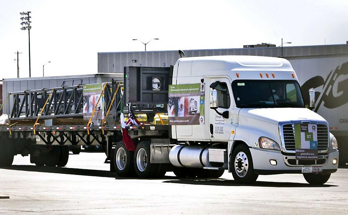 The first commercial truck from Mexico that will travel to Garland, Texas from Apocada, Nuevo Leon, Mexico, enters the U.S. Customs Import Lot for secondary inspection at the World Trade Bridge in Laredo, Texas, Friday, Oct. 21, 2011. For the first time under the North American Free Trade Agreement, a Mexican tractor-trailer has crossed the border into the U.S. on its way into the country's interior. The NAFTA trucking program was stalled for years by concerns that it would put highway safety and American jobs at risk. But the commercial truck hauling a steel drilling structure entered the United States on Friday afternoon, nearly two decades after passage of the agreement, which was supposed to improve cargo transportation between the two countries. (AP Photo/The Laredo Morning Times, Ricardo Santos)