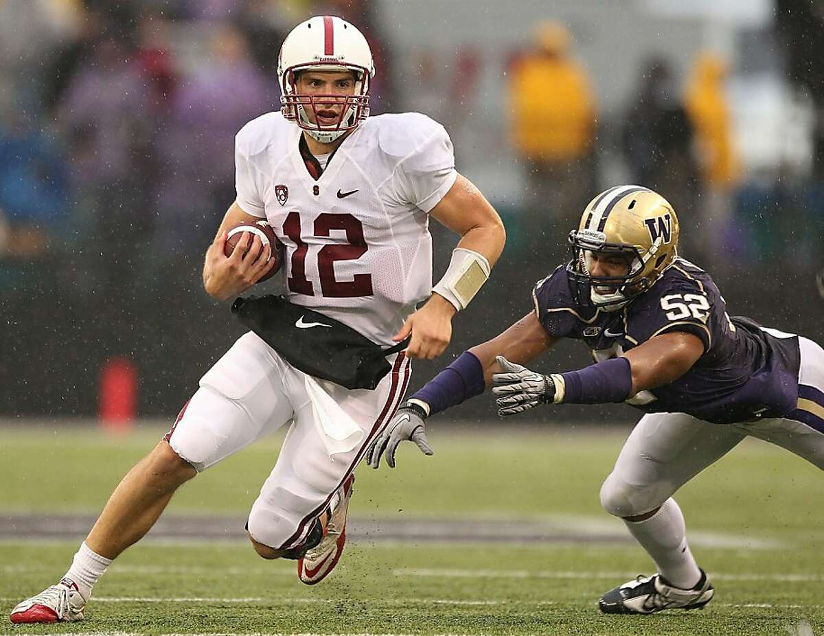 SEATTLE - OCTOBER 30: Quarterback Andrew Luck #12 of the Stanford Cardinal rushes against Hau'oli Jamora #52 of the Washington Huskies on October 30, 2010 at Husky Stadium in Seattle, Washington. (Photo by Otto Greule Jr/Getty Images) Ran on: 10-31-2010 Stanford quarterback Andrew Luck scrambles for a few of his 92 yards rushing, which included a 51-yard touchdown. He also passed for 192 yards and a TD. Ran on: 10-31-2010 Stanford quarterback Andrew Luck scrambles for a few of his 92 yards rushing, which included a 51-yard touchdown.