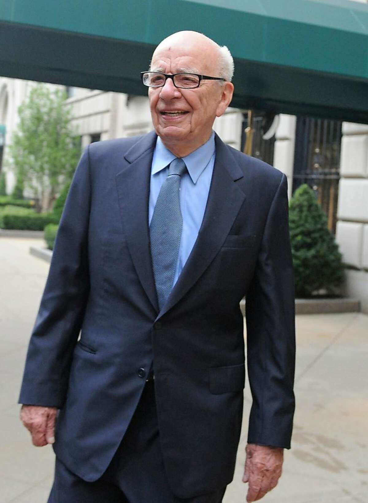 News Corporation head Rupert Murdoch exits his Fifth Avenue residence, Thursday, July 21, 2011, in New York. As the scandal runs its course in the U.K., Murdoch's News Corp. must confront at least two U.S.-based shareholder lawsuits, a possible Standard & Poor's credit downgrade, and the beginnings of a federal investigation. (AP Photo/Louis Lanzano) Ran on: 08-11-2011 Rupert Murdochs News Corp. lost income after the sale of social-networking site Myspace.