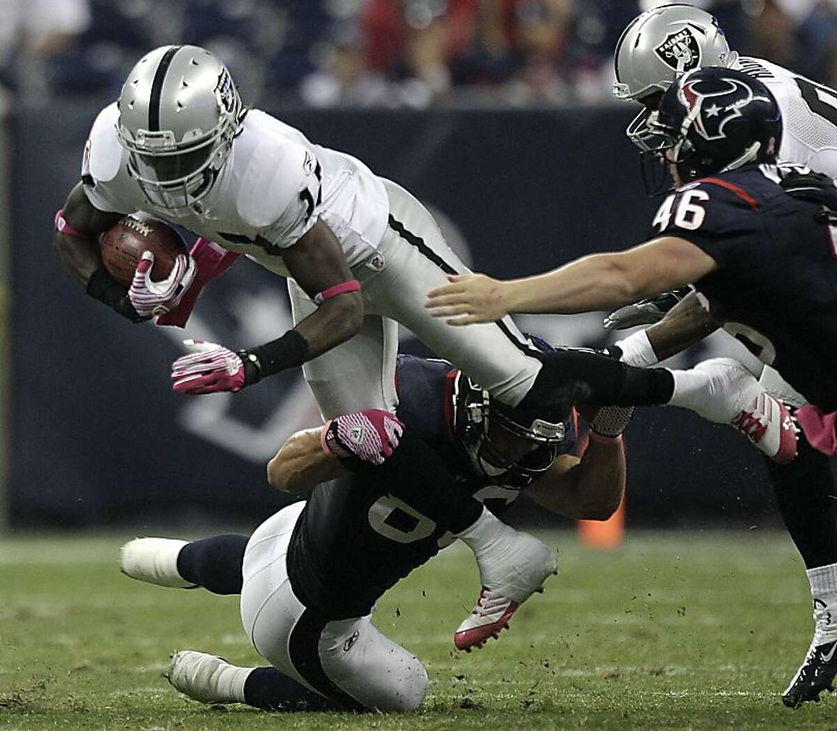 Oakland Raiders wide receiver Denarius Moore (17) is tripped up by Houston Texans tight end James Casey (86) for an 11-yard punt return during the third quarter of an NFL football game at Reliant Stadium on Sunday, Oct. 9, 2011, in Houston. The Raiders beat the Texans 25-20. ( Brett Coomer / Houston Chronicle )