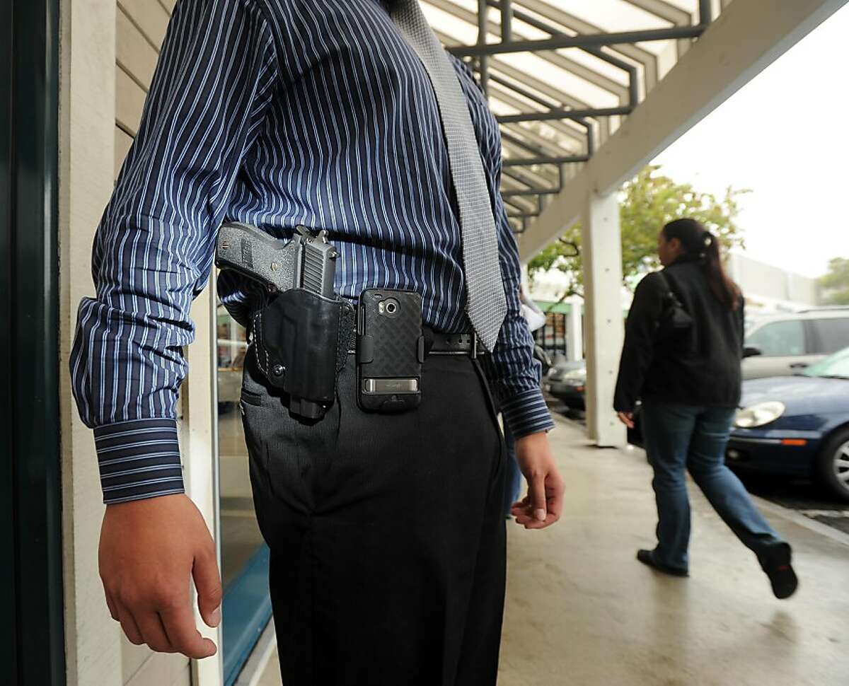 Yih-Chau Chang wears his Sig Sauer P226 .40 caliber handgun on Monday, Oct. 10, 2011, in San Leandro, Calif. Chang opposes a bill signed Sunday by Gov. Jerry Brown that bans open-carry handguns.