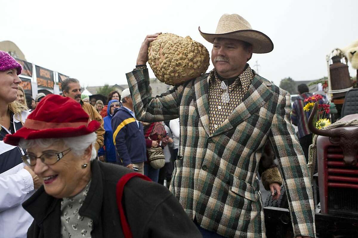 Bev Ashcroft (left) and Kevin Palmer show up dressed as the Beverly Hillbillies to entertain the crowd at the 38th Annual Safeway World Championship Pumpkin Weigh-Off in Half Moon Bay, Calif., on Monday, October 10, 2011.