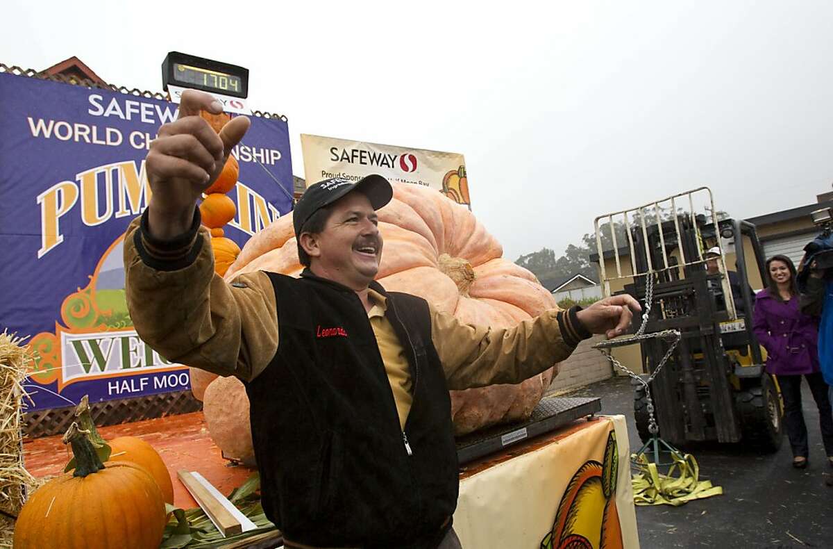 Leonardo Urena from Napa waves to the crowd after his pumpkin was weighed in 1,704 pounds at at the 38th Annual Safeway World Championship Pumpkin Weigh-Off in Half Moon Bay, Calif., on Monday, October 10, 2011. Urena won the contest and set a new California state record with his pumpkin.