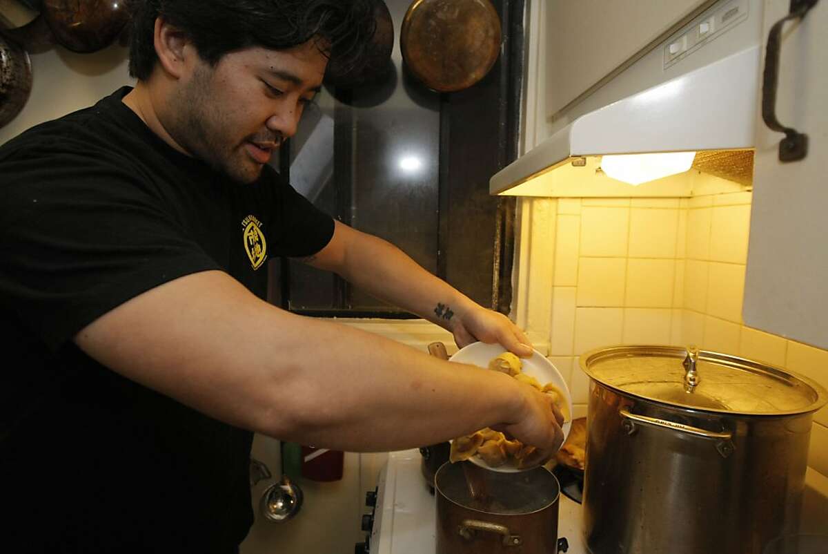 Chef of Bar Agricole Brandon Jew dumps a plate of wontons into a pot of water to cook as he makes his version of wonton soup in his own kitchen in San Francisco Calif., on August 31, 2011.