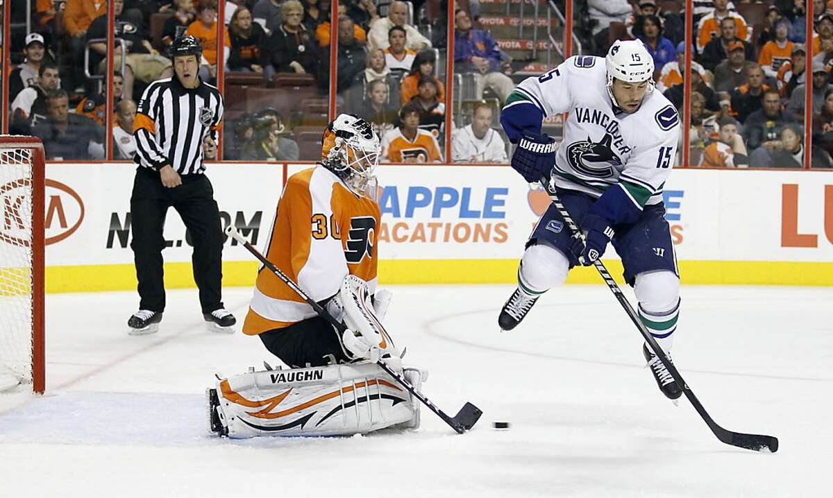 Philadelphia Flyers goalie Ilya Bryzgalov makes the save against Vancouver Canucks' Marco Sturm, right, during the third period at the Wells Fargo Center in Philadelphia, Pennsylvania, on Wednesday, October 12, 2011. The Flyers topped the Canucks, 5-4. (Yong Kim/Philadelphia Daily News/MCT)