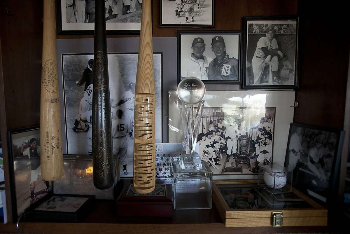A collection of baseball memorabilias and photographs lines the wall at former Major League catcher Charlie Silvera's home in Millbrae, Calif. on Tuesday, Oct. 11, 2011. Silvera, a San Francisco native, played on the Yankees' championship team in the 50's as a catcher alongside Yogi Berra and Elston Howard and remains active today as a scout.