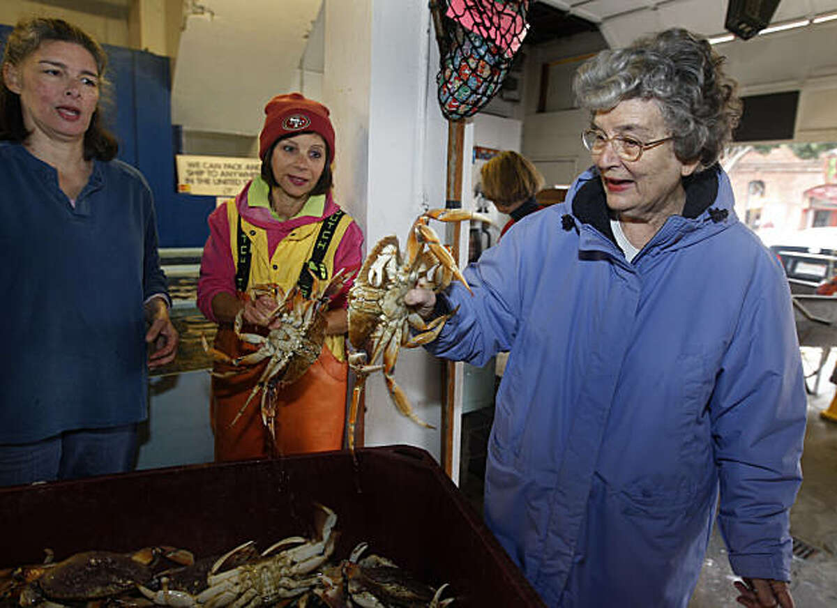 Stephanie Cincotta (right) handles a Dungeness crab with her daughters Angela Cincotta (left) and Annette Traverso (center) at the family-owned Alioto-Lazio Fish Company in San Francisco, Calif., on Friday, Nov. 19, 2010. The Cincotta family has run the business since Stephanie Cincotta's father, Tom Lazio, co-founded the company with Frank Alioto over 50 years ago.
