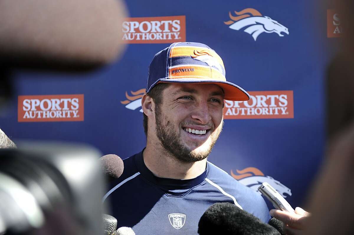 Denver Broncos quarterback Tim Tebow (15) talks to the media after being named the starting quarterback, Tuesday, Oct. 11, 2011, in Englewood, Colo., (AP Photo/Jack Dempsey)
