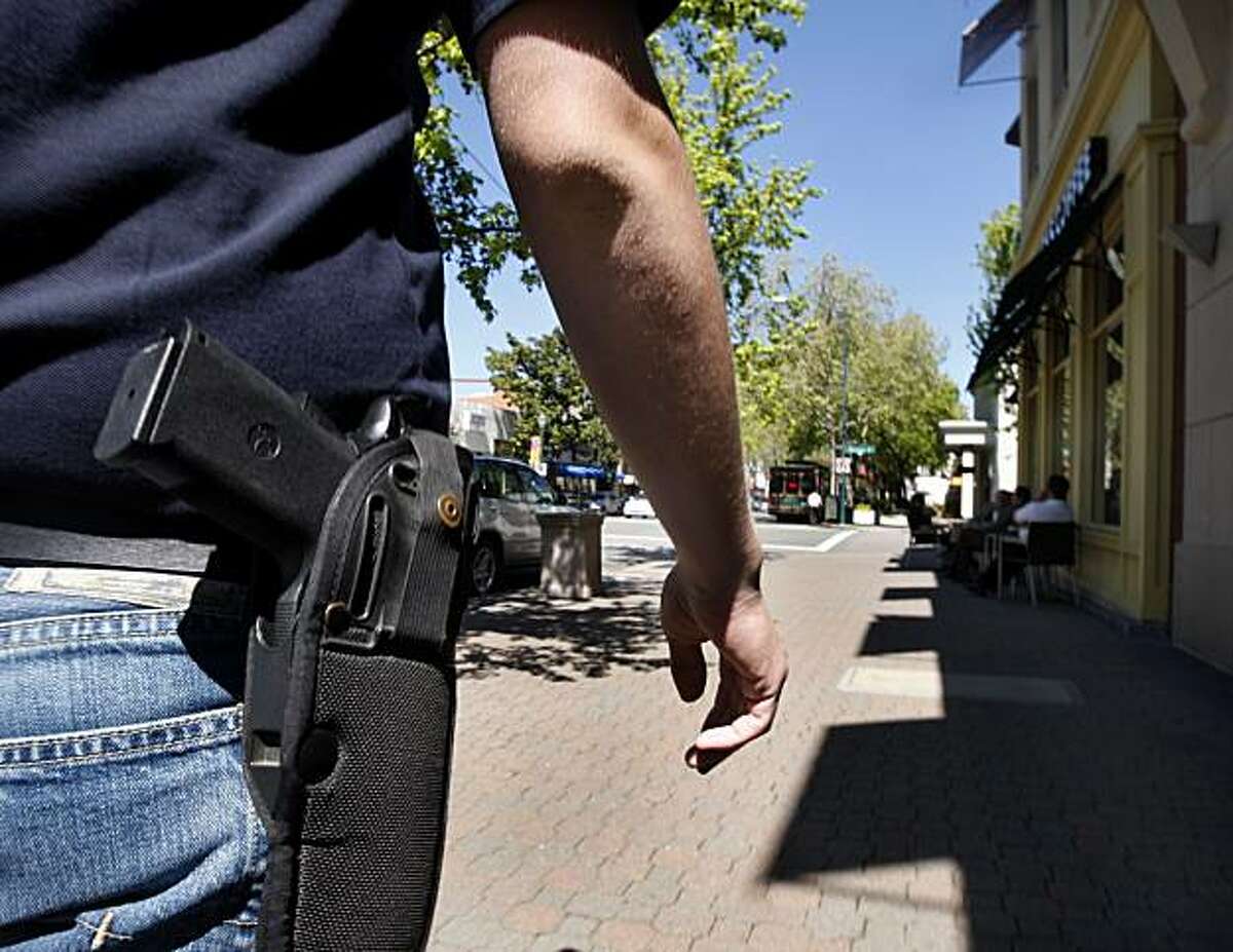 Brad Huffman wears his .45 caliber handgun while walking on North Main Street in downtown Walnut Creek, Calif., on Wednesday, April 7, 2010. Huffman is among a growing number of gun owners that are advocating the "Open Carry" law which allows law abiding citizens to carry holstered unloaded handguns. Ran on: 06-04-2010 Photo caption Dummy text goes here. Dummy text goes here. Dummy text goes here. Dummy text goes here. Dummy text goes here. Dummy text goes here. Dummy text goes here. Dummy text goes here.###Photo: edit04_guns_PH1270425600SFC###Live Caption:Brad Huffman wears his .45 caliber handgun while walking on North Main Street in downtown Walnut Creek, Calif., on Wednesday, April 7, 2010. Huffman is among a growing number of gun owners that are advocating the "Open Carry" law which allows law abiding citizens to carry holstered unloaded handguns.###Caption History:Brad Huffman wears his .45 caliber handgun while walking on North Main Street in downtown Walnut Creek, Calif., on Wednesday, April 7, 2010. Huffman is among a growing number of gun owners that are advocating the "Open Carry" law which allows law abiding citizens to carry holstered unloaded handguns.###Notes:Brad Huffman###Special Instructions:**MANDATORY CREDIT FOR PHOTOG AND SF CHRONICLE-NO SALES-MAGS OUT-TV OUT-INTERNET: AP MEMBER NEWSPAPERS ONLY**
