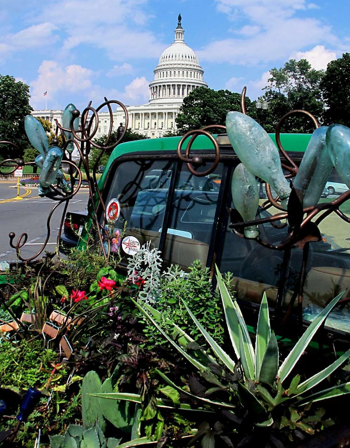 Slow Gardening 0813 Author Felder Rushing transformed the bed of his father's 1988 Ford F-150 pickup truck into a flower bed to prove that, yes, you can garden anywhere. His rolling garden, shown parked near the Capitol in Washington, D.C., is complete with bottle trees and wind chimes. Credit: Felder Rushing