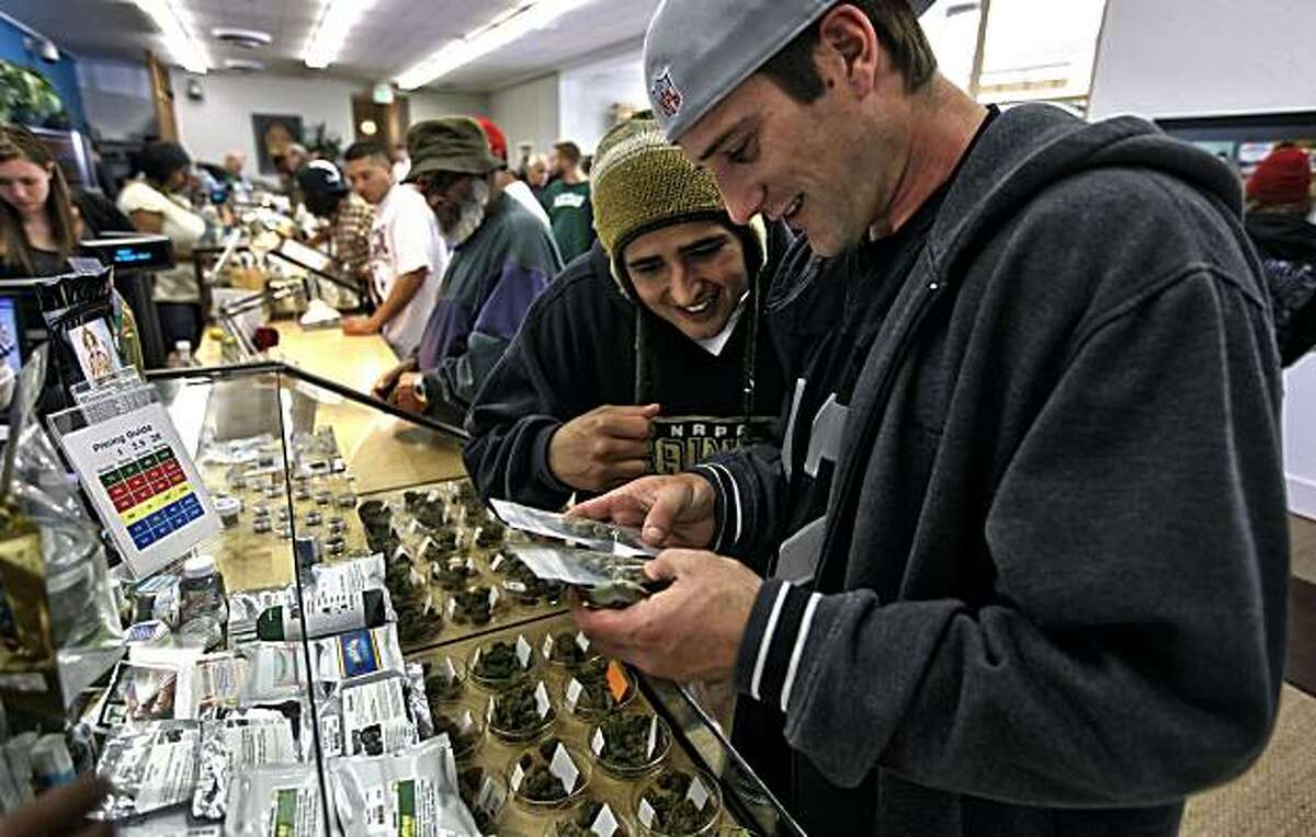 George Ross, (center) and his friend Matt Rasmussen,(right) both from Napa, check out the different varieties of marijuana available at the Harborside Health Center in Oakland, Calif. on Tuesday Apr. 20, 2010, the company is a dispensary of medical marijuana. Ran on: 05-03-2010 Matt Rasmussen (right) and George Ross of Napa check out the types of marijuana available at the Harborside Health Center in Oakland, the nation's largest medical marijuana dispensary. Ran on: 05-03-2010 Matt Rasmussen (right) and George Ross of Napa check out the types of marijuana available at the Harborside Health Center in Oakland, the nation's largest medical marijuana dispensary.