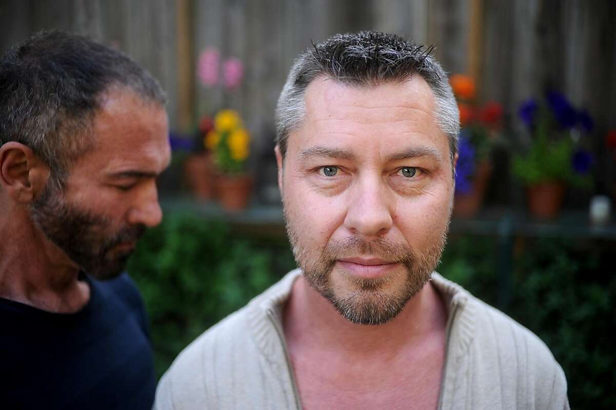 Anthony Makk, right, spends time with husband Bradford Wells on Monday, Aug. 8, 2011, at their San Francisco home. Though legally married in 2004, Makk faces deportation back to his native Australia.