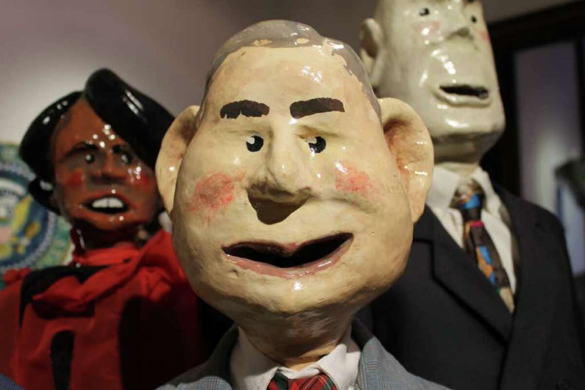 Puppets by Ed Atkeson of George W. Bush (front) with Condoleeza Rice (left) and John Ashcroft (right). (Michael Janairo / Times Union)