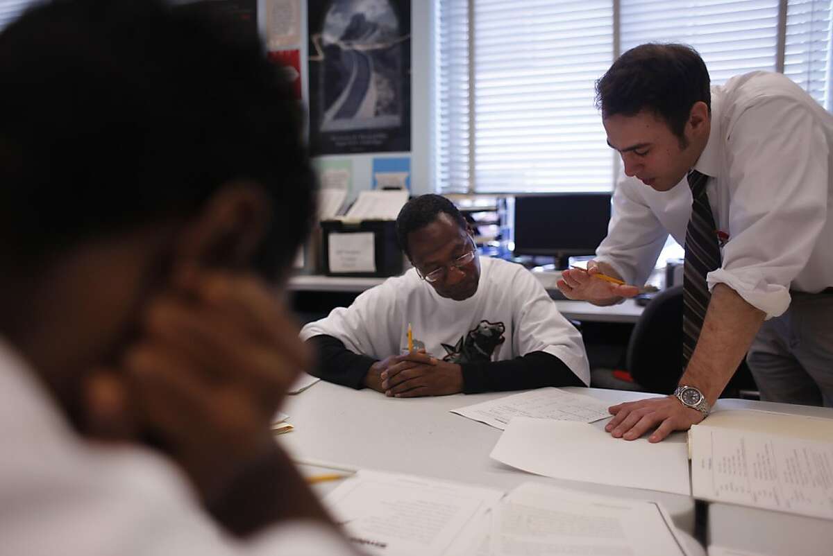 Mario Silano (right), instrtuctor, works with Milton Washington (center) of San Francisco on class work to get his GED at the 5 Keys Charter School Adult Probation Department Learning Center at the Hall of Justice in San Francisco, Calif., on Friday, September 30, 2011.