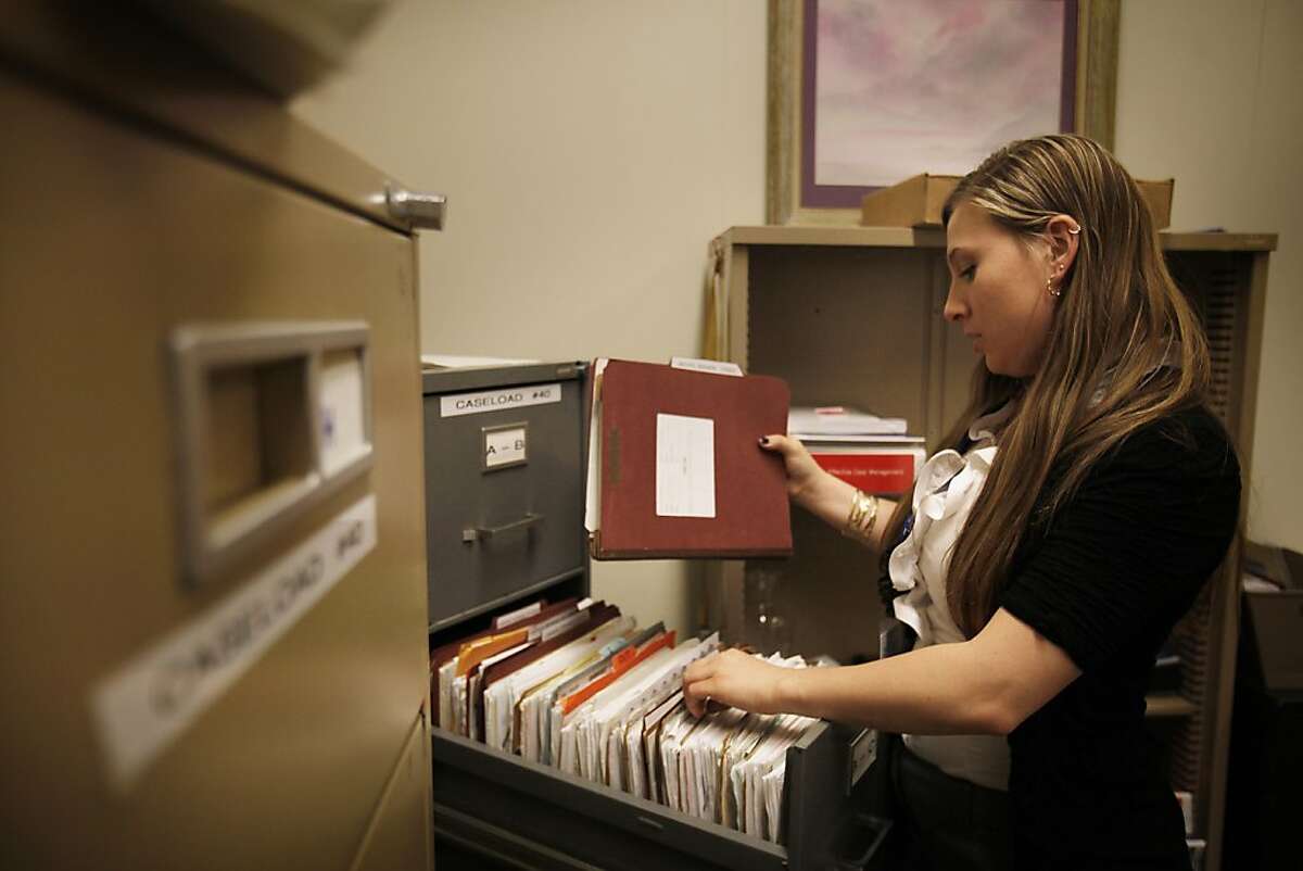 Christina Balistreri, deputy probation officer who is transitioning to work in the new Post Release Community Service (PRCS) unit as a pre release officer, organizes paperwork and files for the new job at the Hall of Justice in San Francisco, Calif., on Friday, September 30, 2011.
