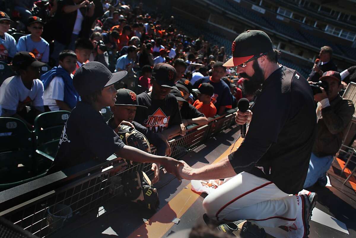 San Francisco Giants closer Brian Wilson shakes the hand of a young fan as he hands out gloves to youth from the Giant's Community Fund's Junior Giants baseball program at AT&T Park on Thursday, July 7, 2011 in San Francisco, Calif. Wilson treated over 1000 children to a question and answer session, tickets to the Giants/Padres game and a new Wilson baseball glove. The children are members of Junior Giants leagues from the Bayview Hunter's Point YMCA, Boys & Girls Clubs of San Francisco, San Francisco Police Activities League and San Francisco Recreation & Parks Department.