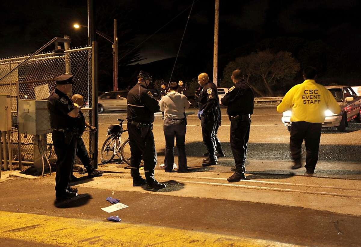A police officers investigate the scene of a shooting just outside of lot L at Candlestick Park, where the San Francisco 49ers had just finished playing the Oakland Raiders in San Francisco, Calif. on Saturday August 20, 2011.