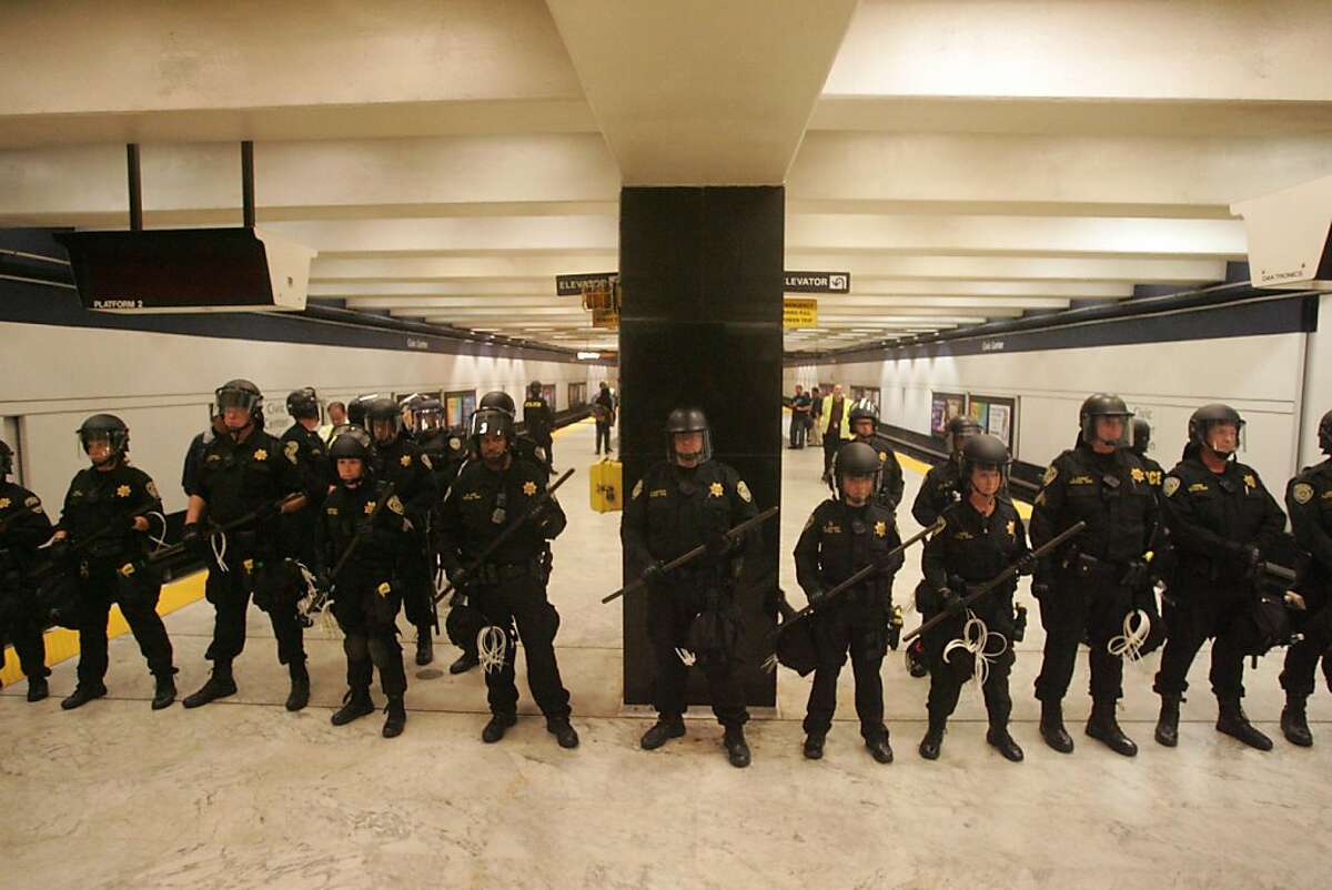 BART police line up to clear the Civic Center BART station during a protest against the BART Police. Ran on: 08-23-2011 BART police line up to clear the Civic Center Station during a protest over a shooting and subsequent wireless blackout.