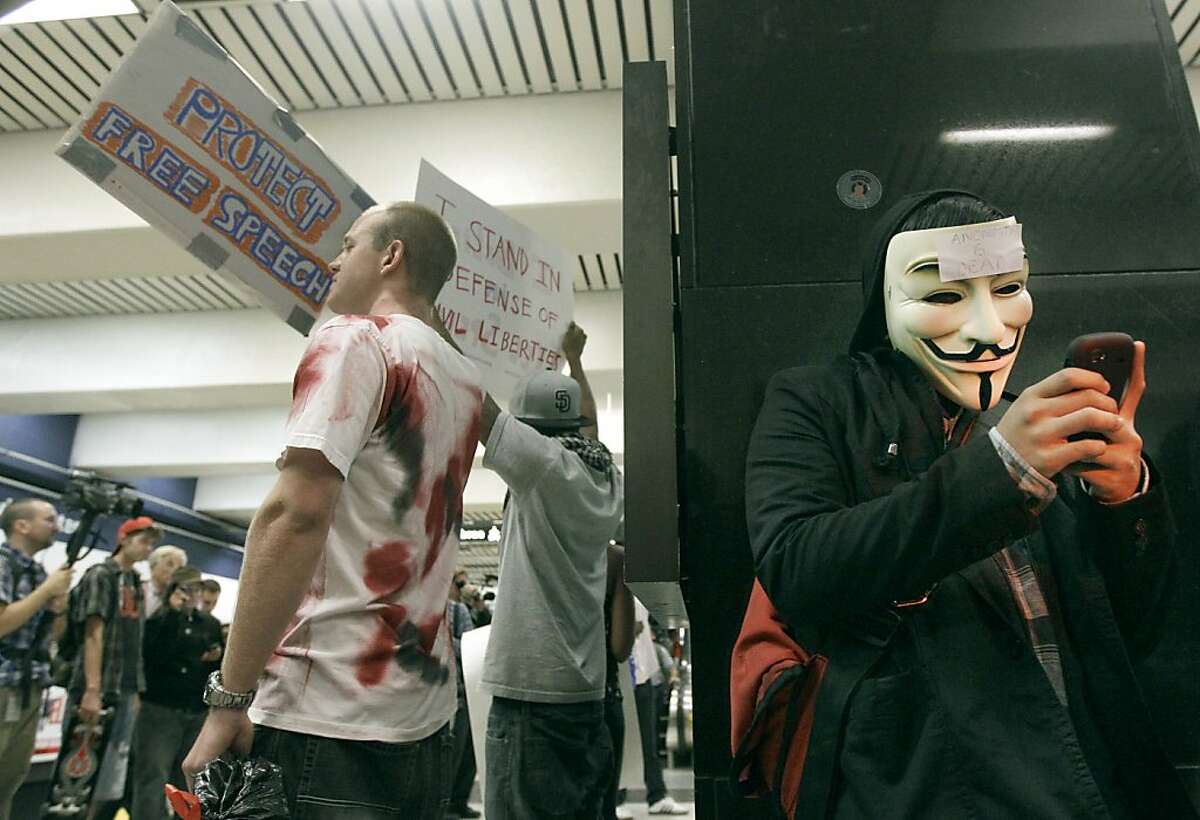 An unidentified protester uses his cell phone during a protest at the Civic Center BART station in San Francisco, Monday, Aug. 15, 2011. Cellphone service was operating as protesters gathered at the San Francisco subway station during rush-hour several days after transit officials shut wireless service to head off another demonstration. (AP Photo/Jeff Chiu)