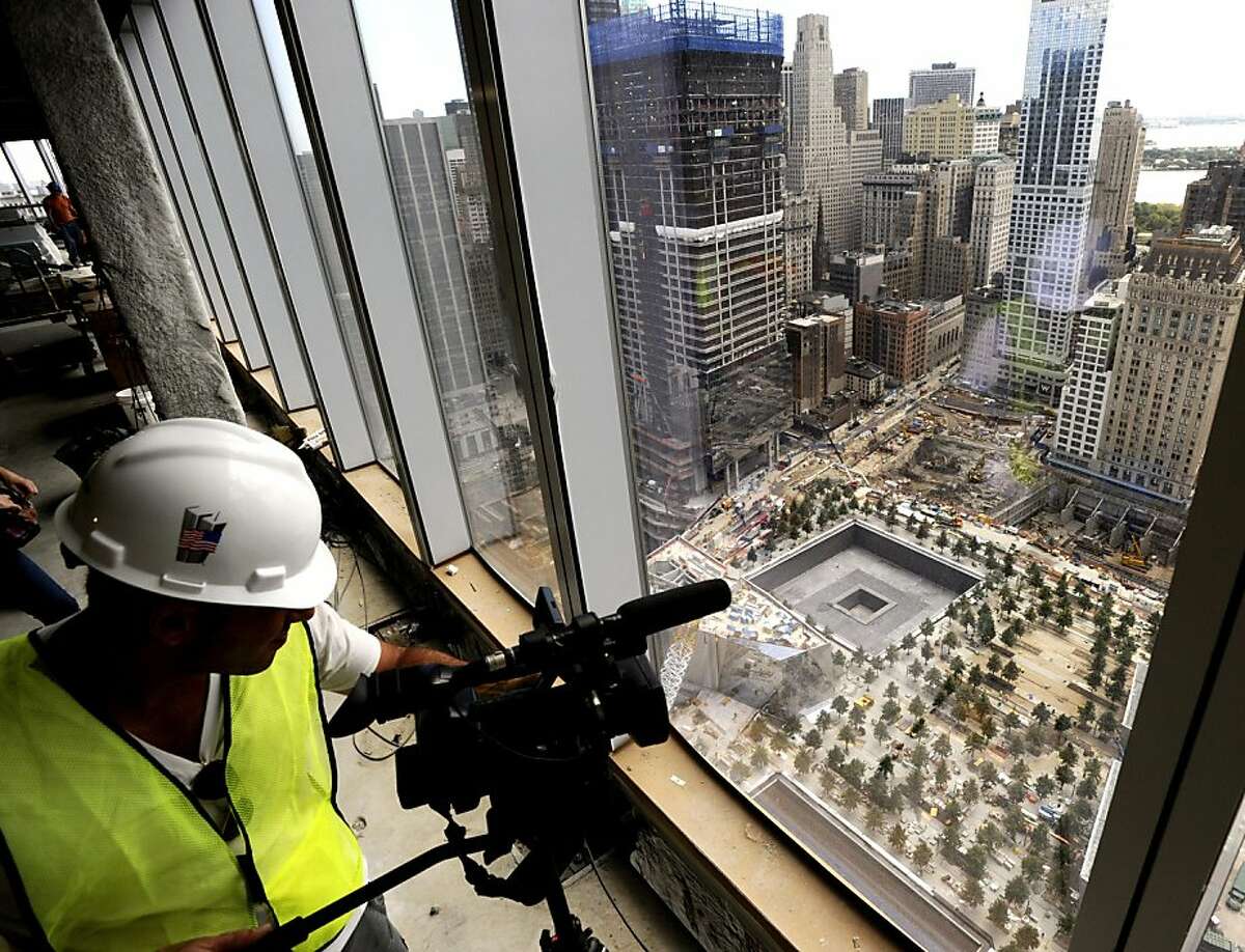 A cameraman documents the footprints of the World Trade Center towers from the 39th floor of the Freedom Tower, also known as One World Trade Center, New York City, Thursday, Aug. 11, 2011, under construction a month before the 10th anniversary of 9/11.