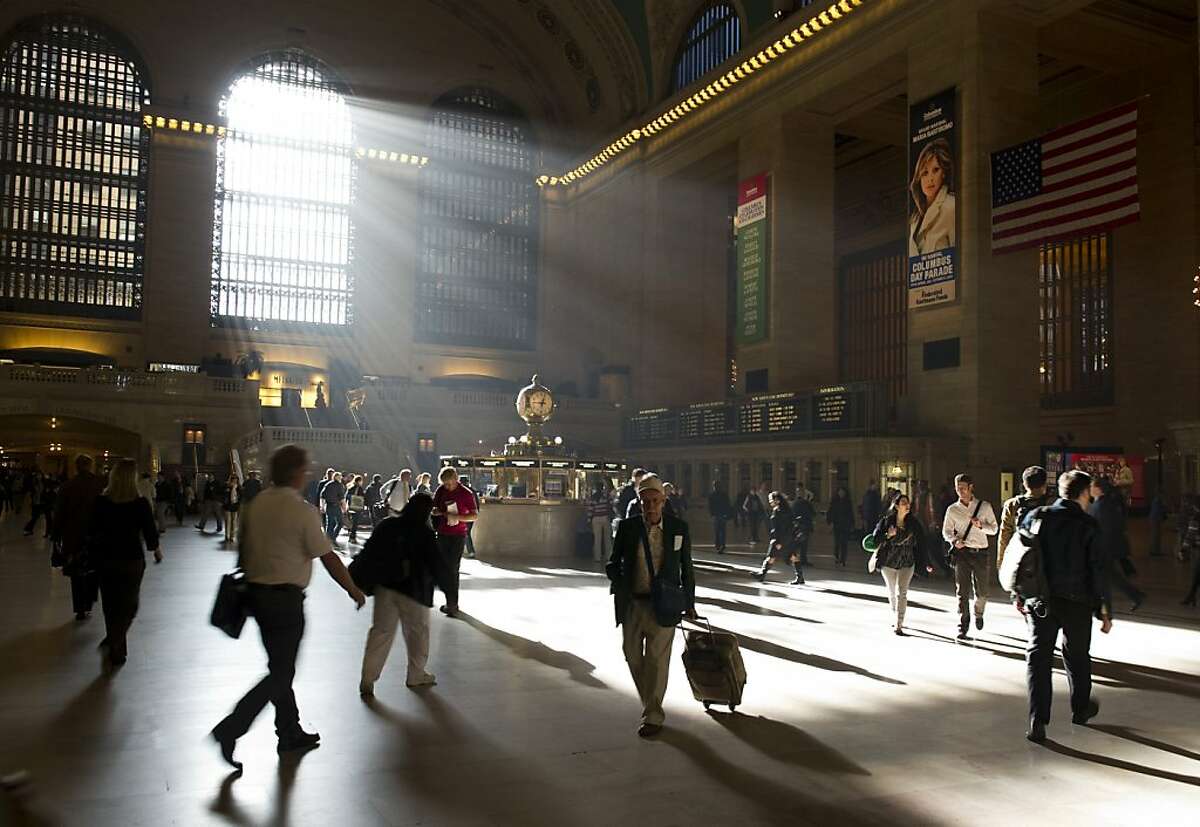 Commuters make their way through Grand Central Terminal as the sun shines in through the eat windows October 13, 2010 in New York. Commuters make their way through Grand Central Terminal as the sun shines in through the eat windows October 13, 2010 in New York. The station offers service to Westchester, Putnam, and Dutchess counties in New York State, Fairfield and New Haven counties in Connecticut as well as to the New York City subway system. AFP PHOTO DON EMMERT/dre (Photo credit should read DON EMMERT/AFP/Getty Images)