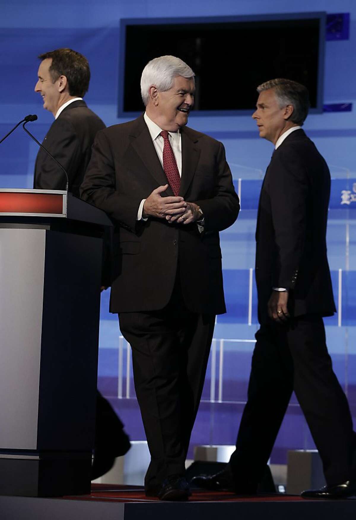 Republican presidential candidates former Minnesota Governor Tim Pawlenty (L),, former House Speaker Newt Gingrich (C), former Utah Gov. Jon Huntsman (R) are pictured at the end of a commerical break during the Iowa GOP/Fox News Debate at the CY Stephens Auditorium in Ames, Iowa, on Thursday, August 11, 2011. Republican White House hopefuls flooded the farm state of Iowa for a closely-watched debate and straw poll which could weed out the crop of 2012 challengers to US President Barack Obama. AFP PHOTO / Pool / Charlie Neibergall (Photo credit should read Charlie Neibergall/AFP/Getty Images)