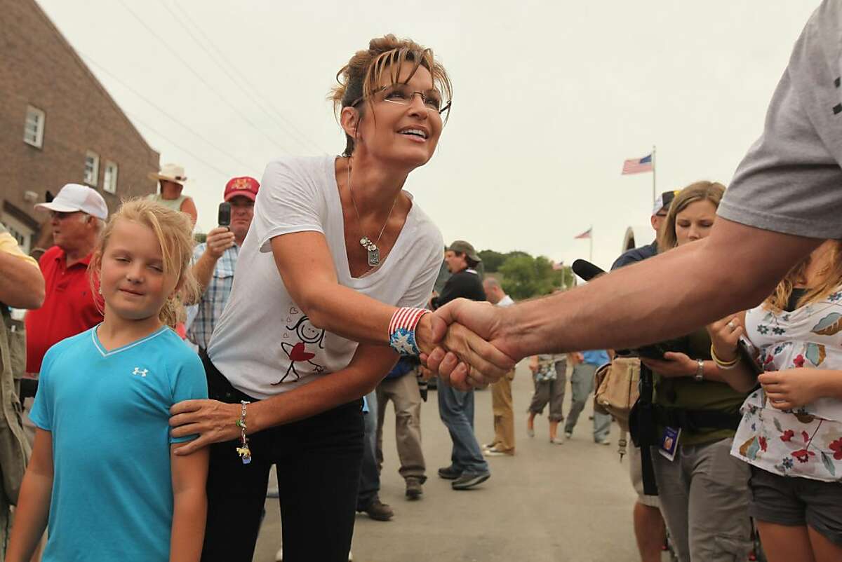 DES MOINES, IA - AUGUST 12: Former Alaska Governor Sarah Palin shakes hands with fairgoers while visiting the Iowa State Fair August 12, 2011 in Des Moines, Iowa. Although she has not announced any intention of running for president, all of the Republican presidential hopefuls are visiting the fair ahead of Saturday's Iowa Straw Poll to greet voters and engage in traditional Iowa campaigning rituals. (Photo by Chip Somodevilla/Getty Images)