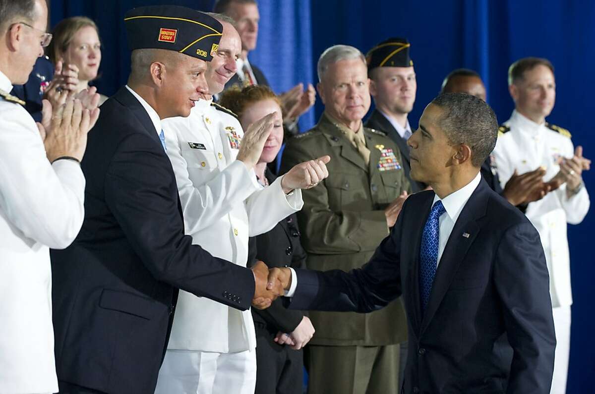 US President Barack Obama shakes hands with military leaders after speaking about the economy and employing US military veterans at the Washington Navy Yard in Washington, DC, on August 5, 2011. Obama assured the world Friday that the powerhouse US economy would recover after a tumultuous year, as fears rise that a stagnant recovery could degenerate into another recession. "What I want the American people and our partners around the world to know is this: we are going to get through this, things will getbetter," Obama said, following turmoil on world markets partly caused by US economic woes.