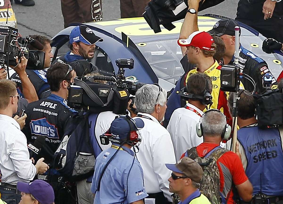 Jimmie Johnson, left, and Kurt Busch exchange words on pit road after the NASCAR Sprint Cup Series auto race, Sunday, Aug. 7, 2011, at Pocono Raceway in Long Pond, Pa.