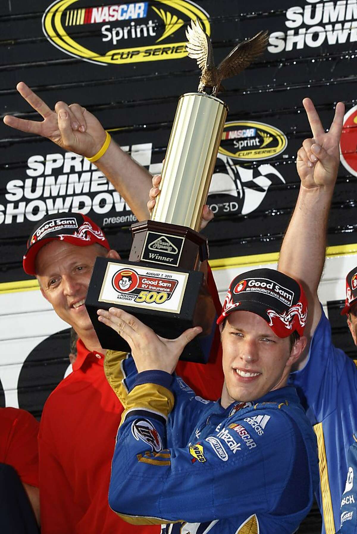 Brad Keselowski holds the trophy in victory lane after winning the NASCAR Sprint Cup Series auto race, Sunday, Aug. 7, 2011, at Pocono Raceway in Long Pond, Pa.