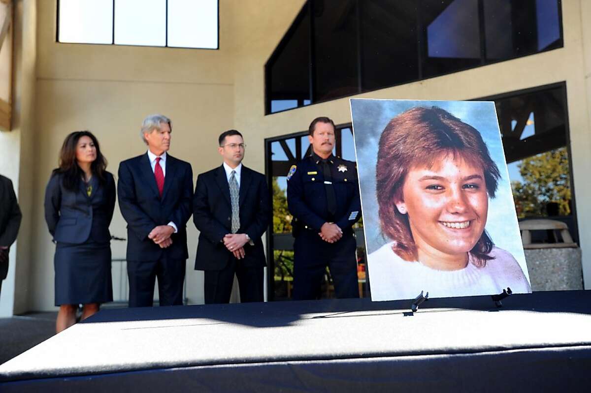 Law enforcement personnel stand behind a photo of Tina Faelz, who was 14 years old when murdered, during a press conference at the Pleasanton Police Department on Monday, Aug. 8, 2011, in Pleasanton, Calif. Police announced Monday they have arrested a suspect in the 1984 stabbing case using DNA evidence.