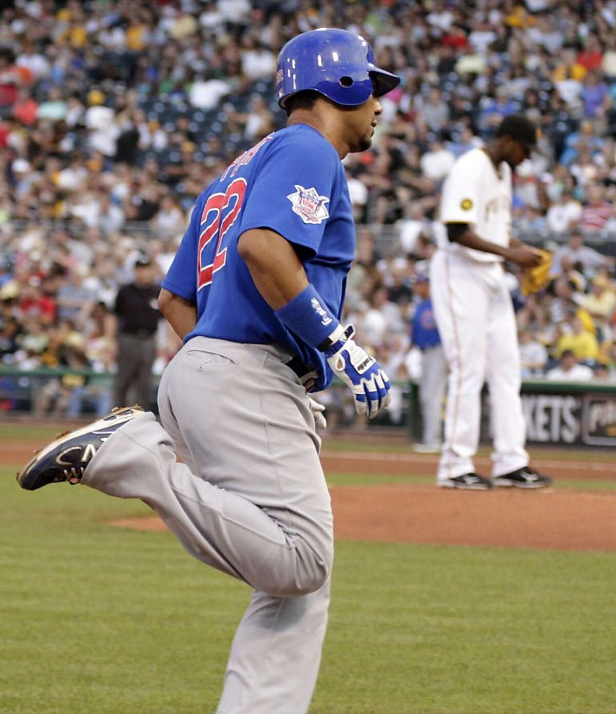 Chicago Cubs' Carlos Pena, left, rounds third after hitting a two-run home run off Pittsburgh Pirates pitcher James McDonald, right rear, in the fourth inning of a baseball game Thursday, Aug. 4, 2011, in Pittsburgh.