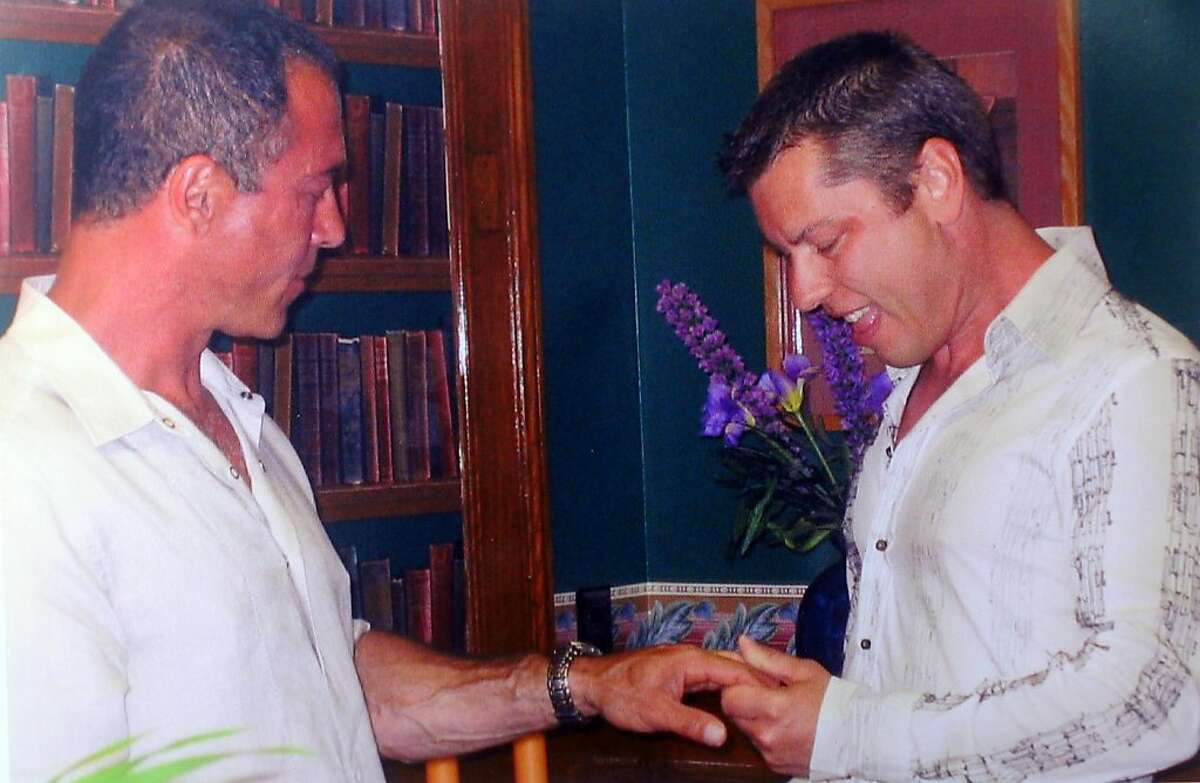In a handout photo provided by the Makk-Wells family, Anthony Makk, right, weds husband Bradford Wells in a 2004 ceremony in Massachusetts.