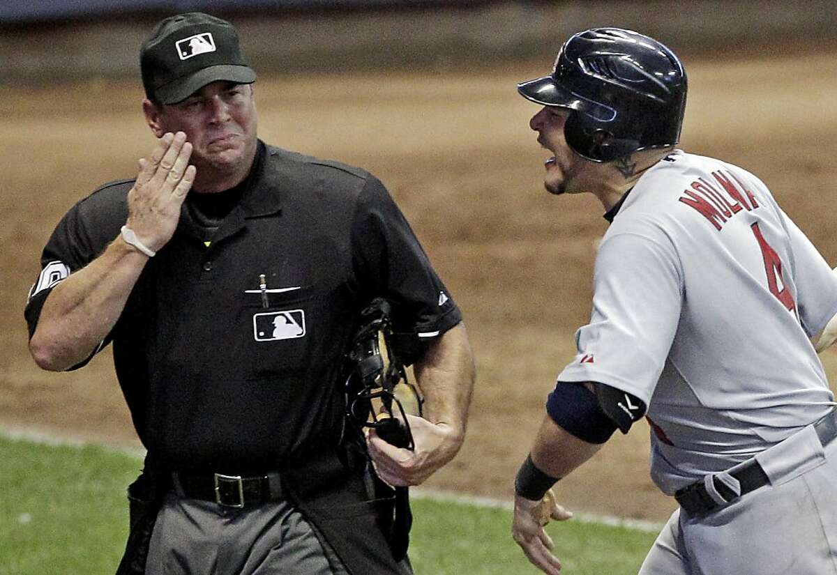 St. Louis Cardinals' Yadier Molina argues with home plate umpire Rob Drake after being called out on strikes during the 10th inning of a baseball game against the Milwaukee Brewers Tuesday, Aug. 2, 2011, in Milwaukee.